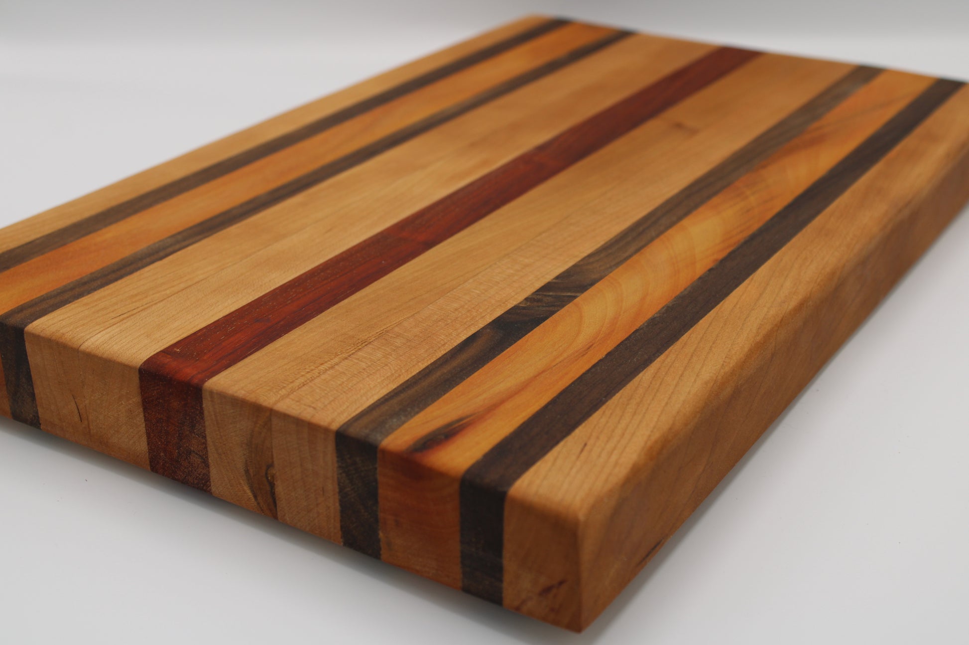 Wooden cutting board with striped pattern on a white background