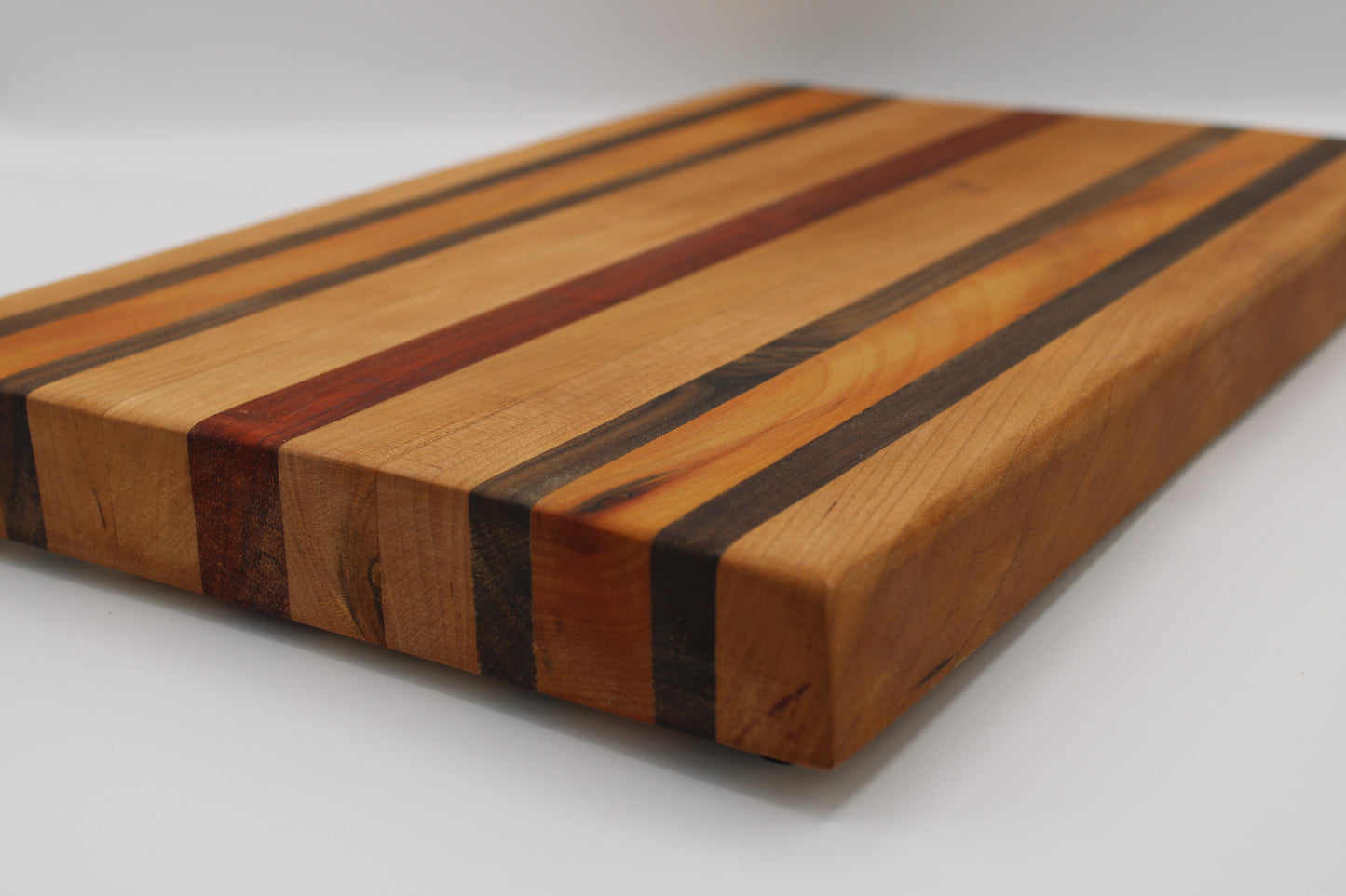 Wooden cutting board with striped pattern on a white background