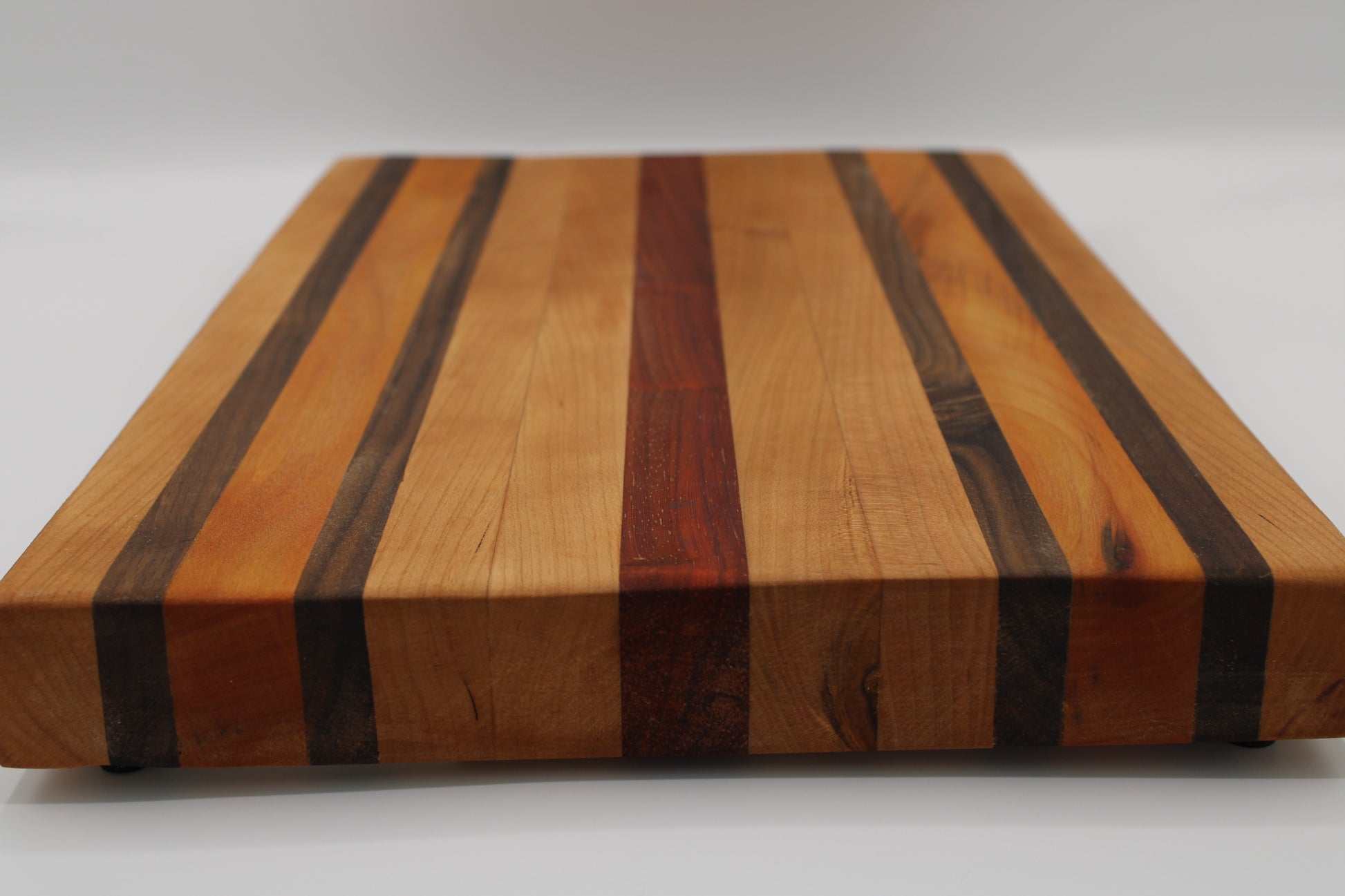 Wooden cutting board with striped pattern on a white background