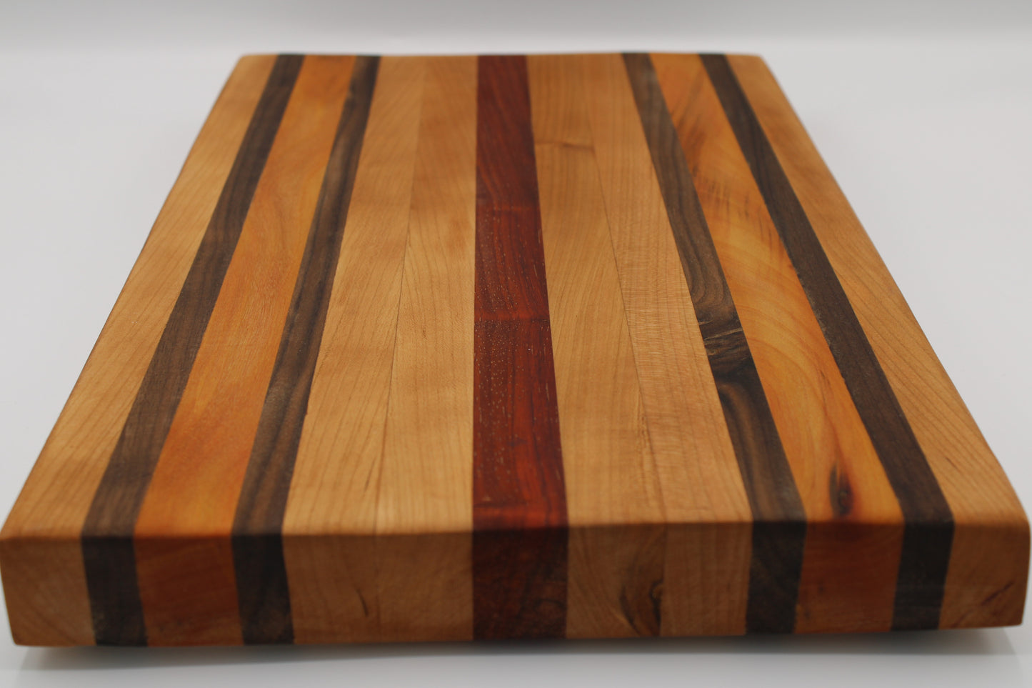 Wooden cutting board with striped pattern on a white background