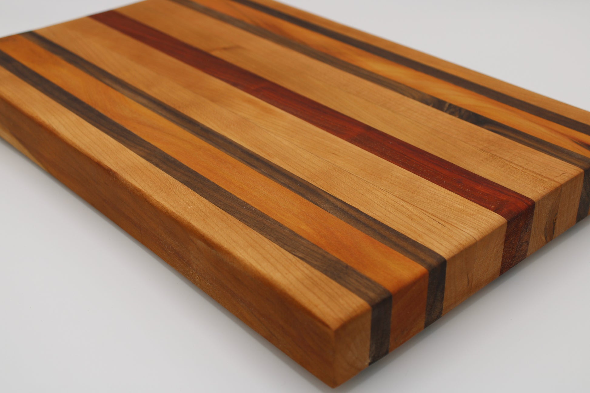 Wooden cutting board with striped pattern on a white background