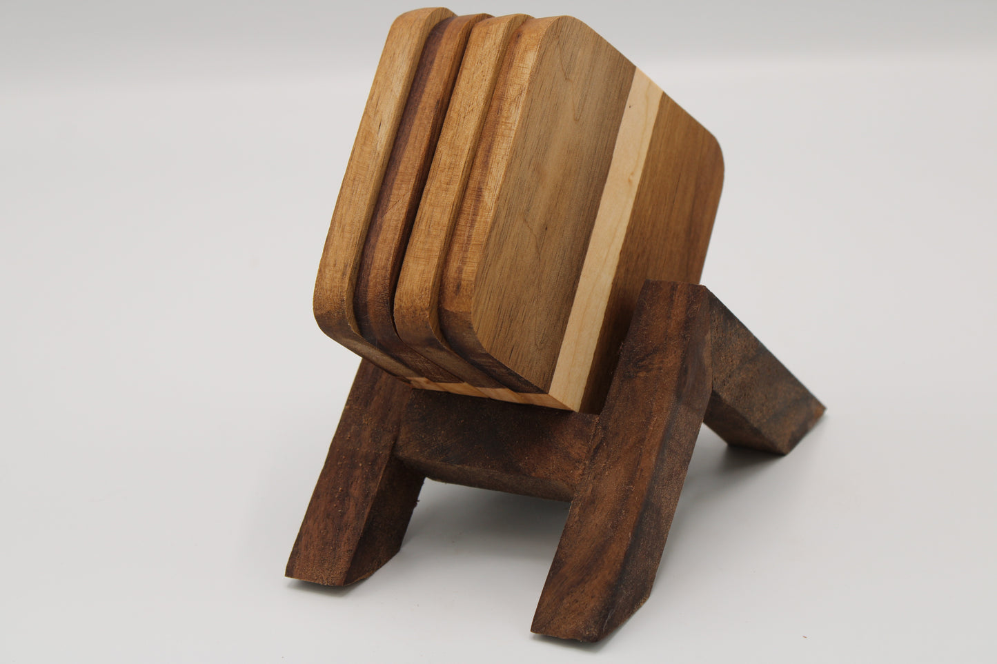 Wooden coaster set with holder on a white background