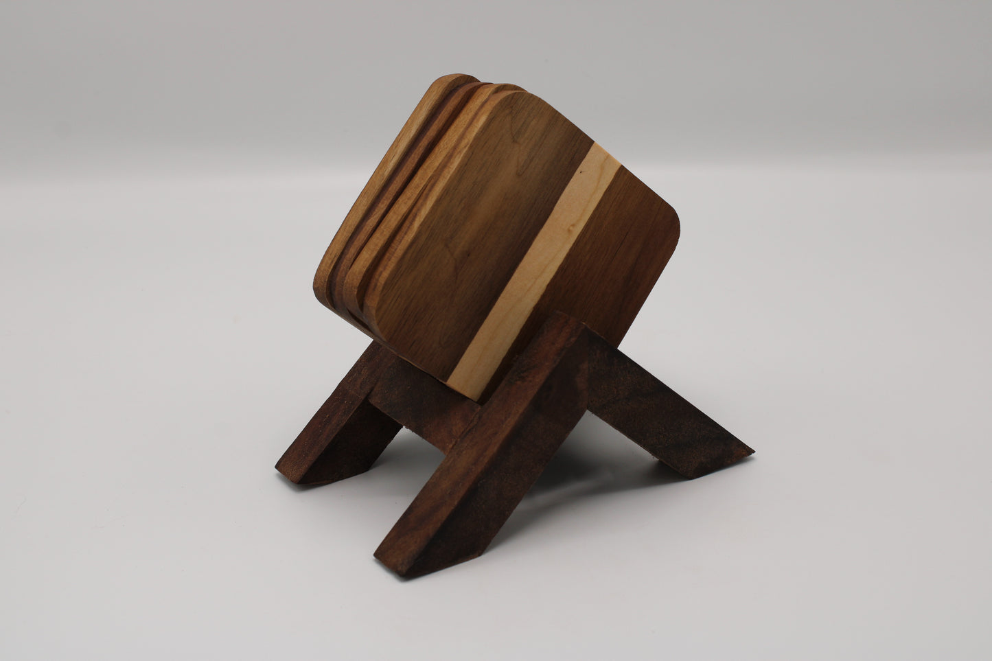 wooden coasters in a stand on a white background