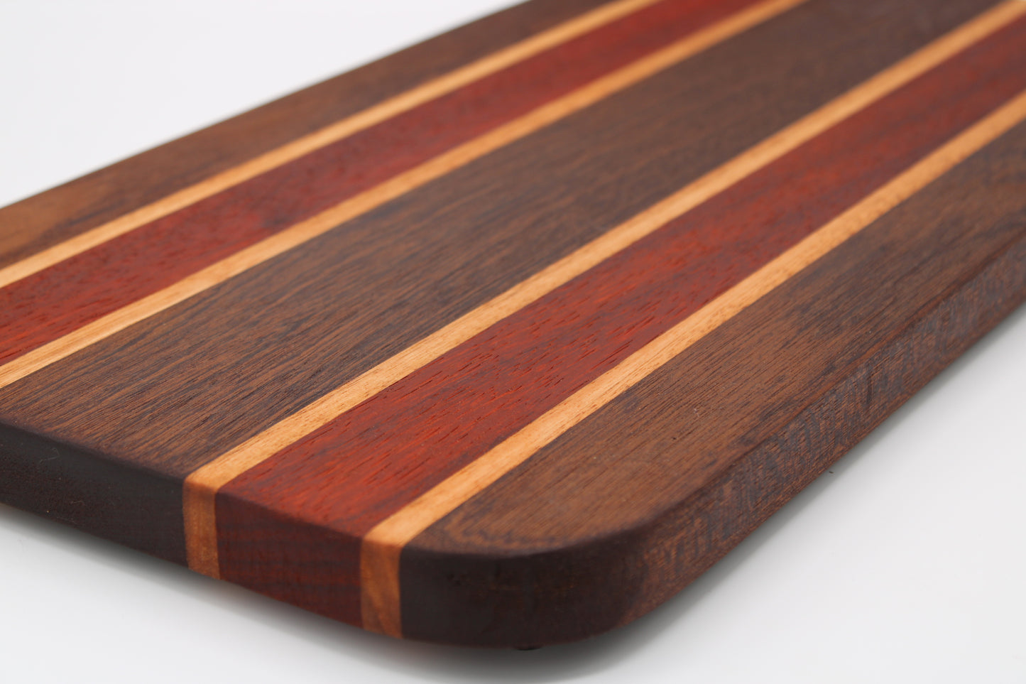 Wooden cutting board with striped pattern on a white background