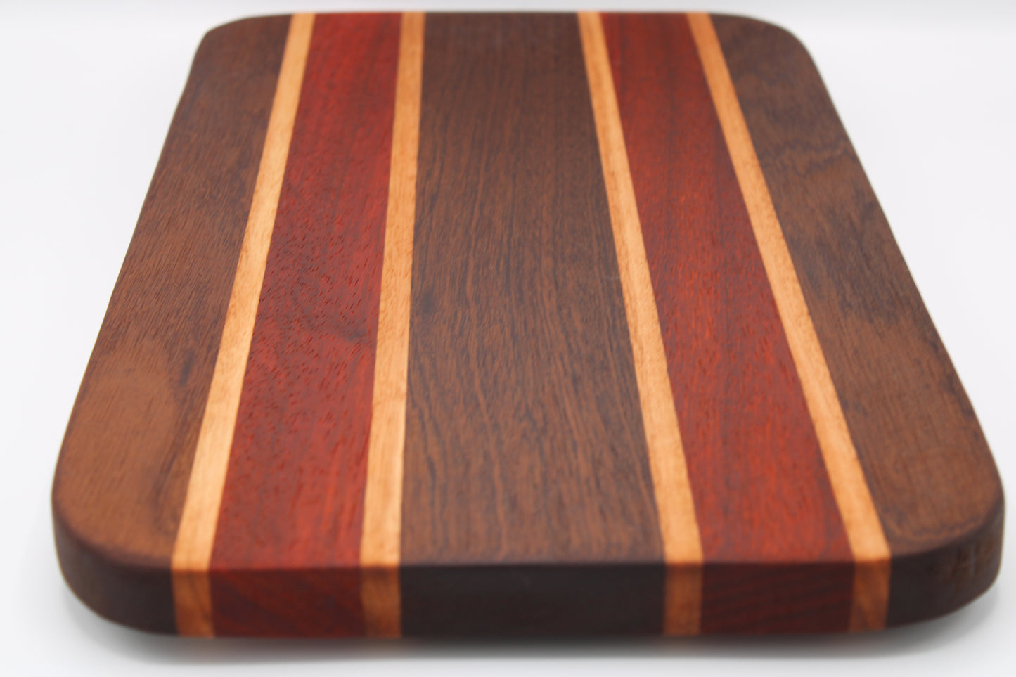 Wooden cutting board with striped pattern on a white background