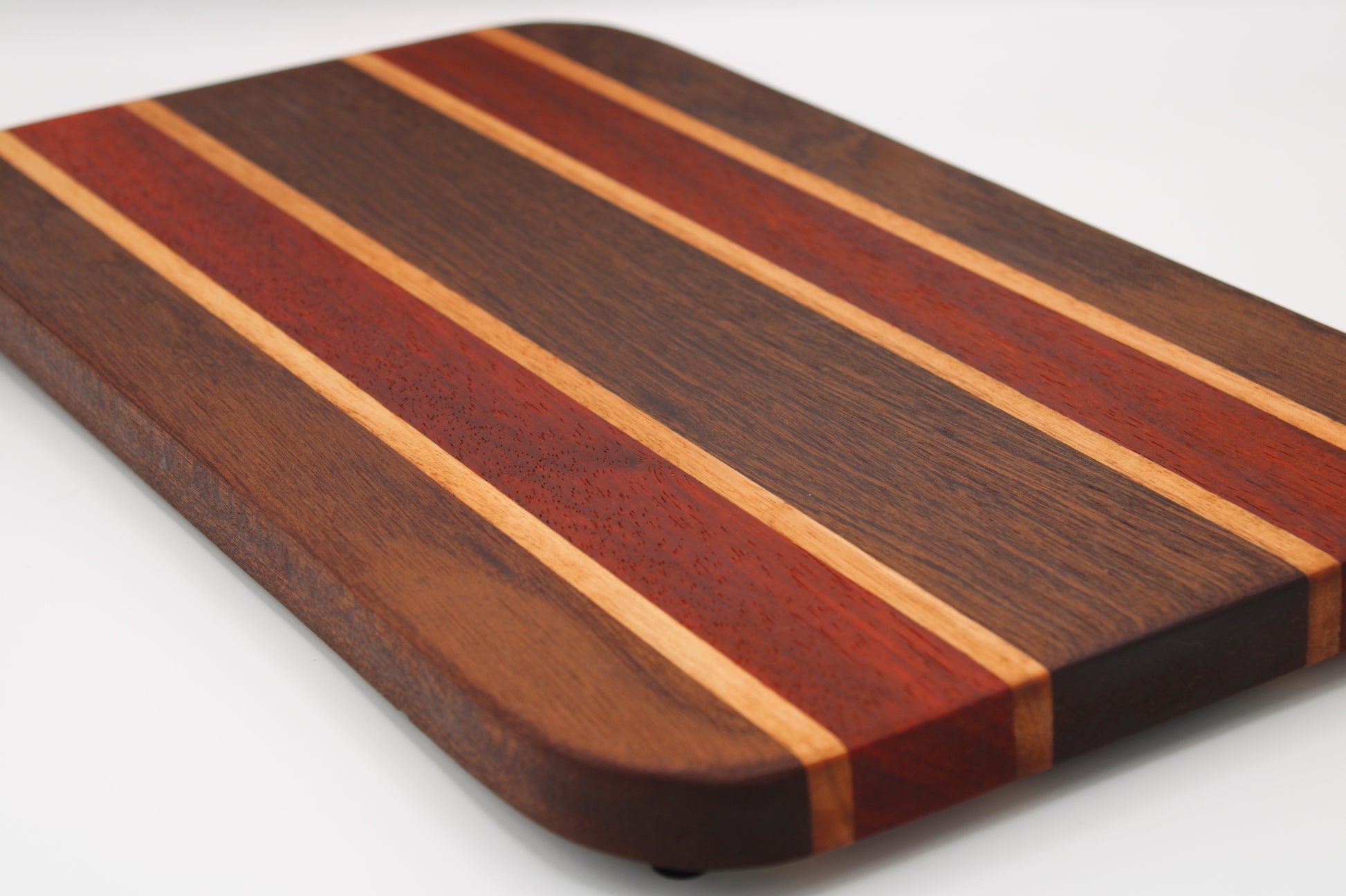 Wooden cutting board with striped pattern on a white background