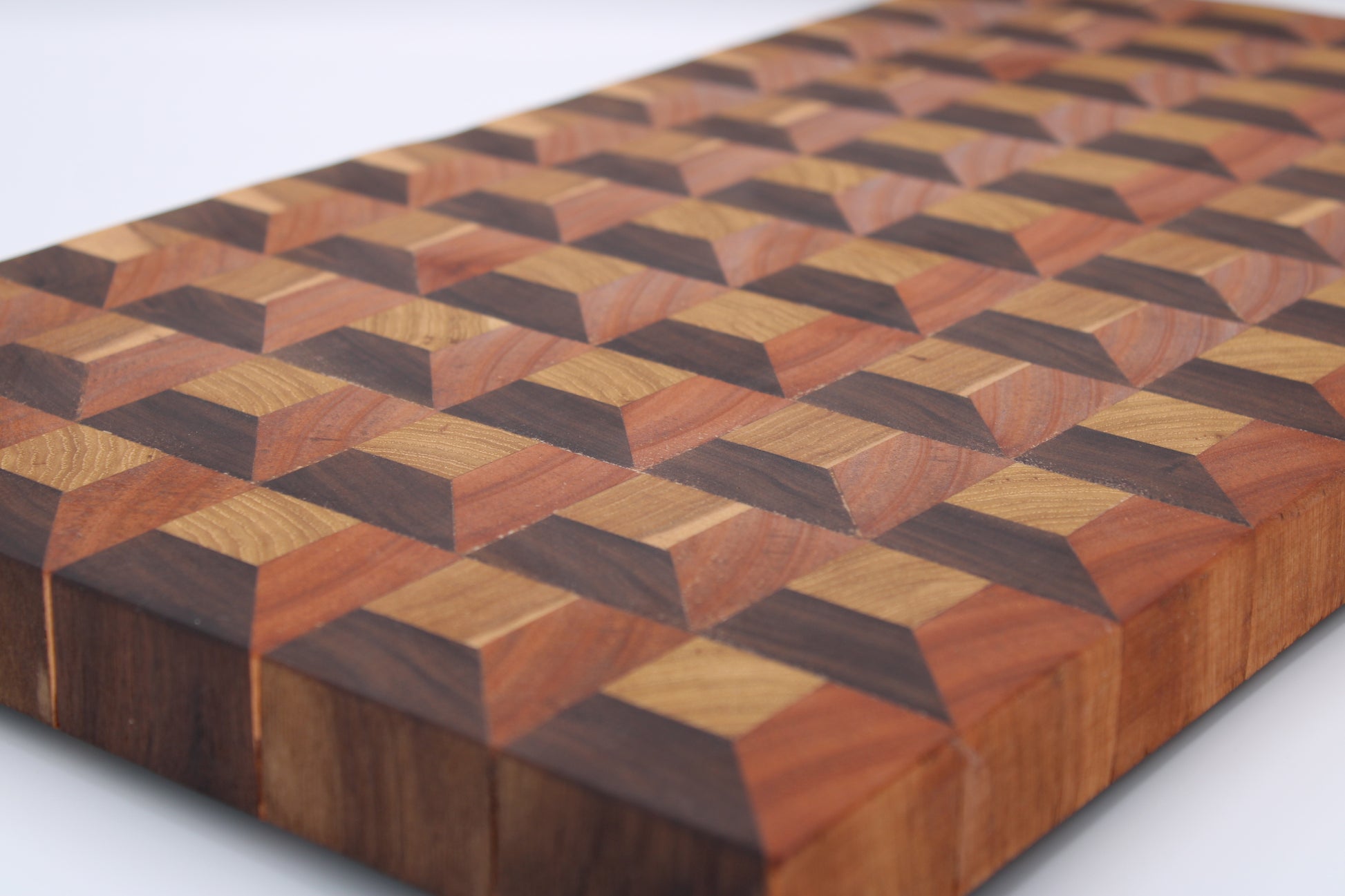Wooden cutting board with geometric pattern on a white background