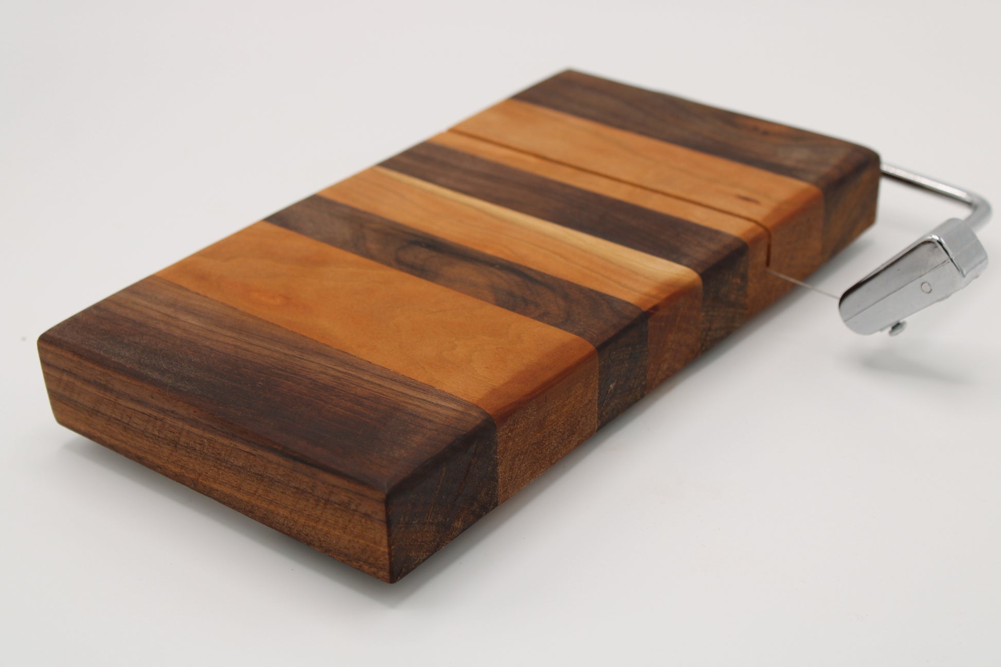 Wooden cheese  board with slicer on a white background