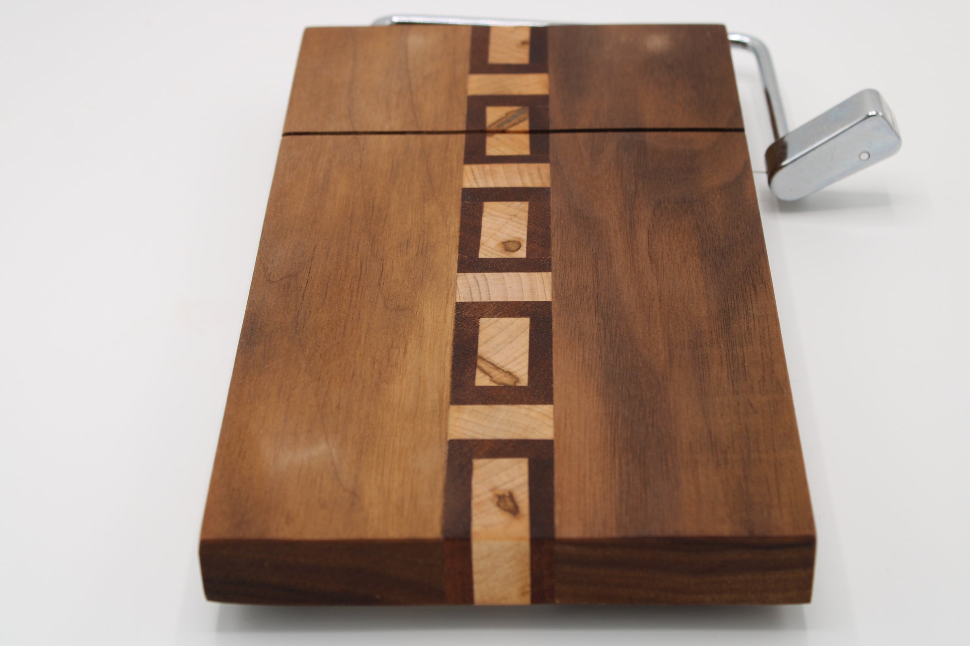 Wooden cutting board with a knife sharpener on a white background