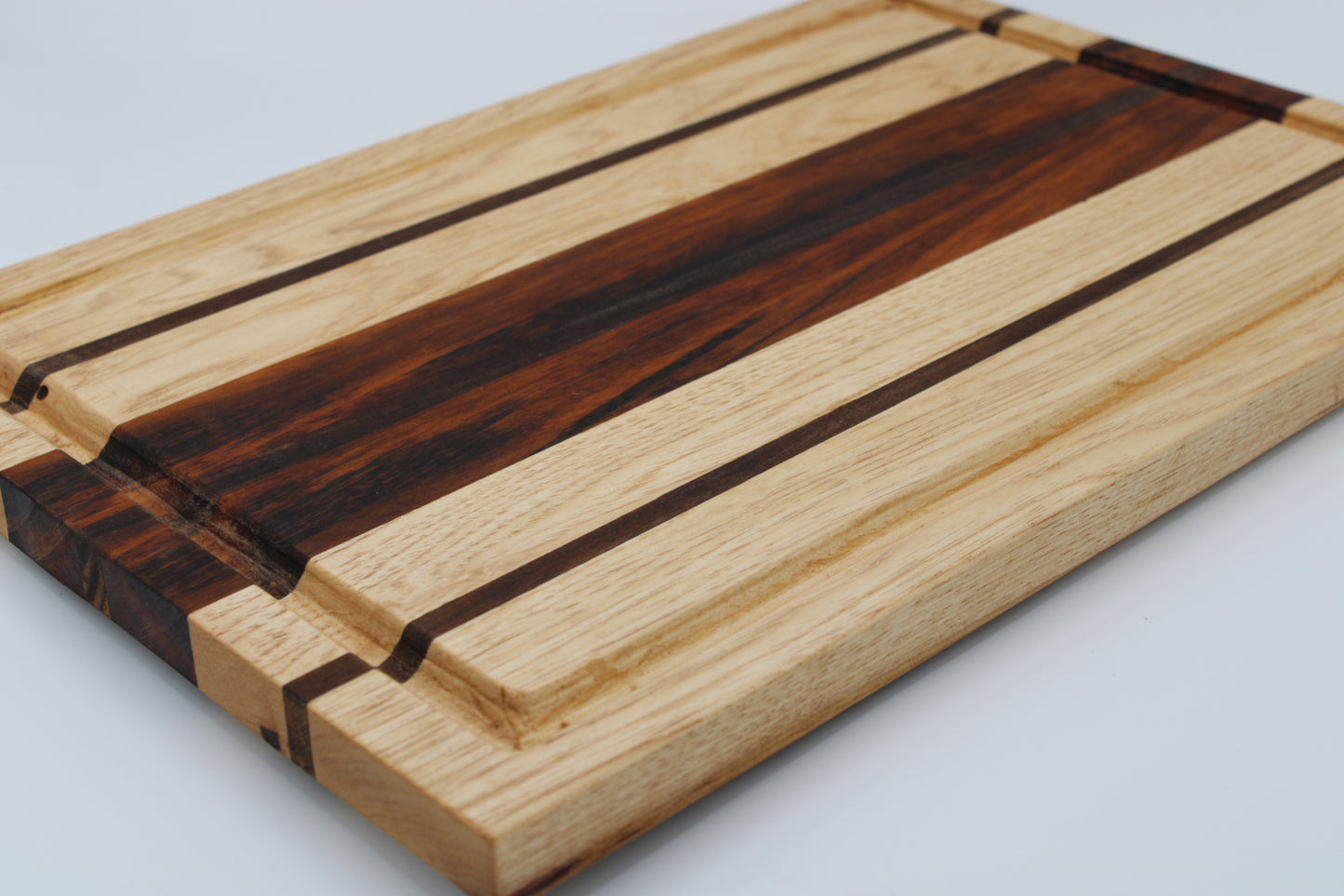 Wooden cutting board with a striped pattern on a light gray background