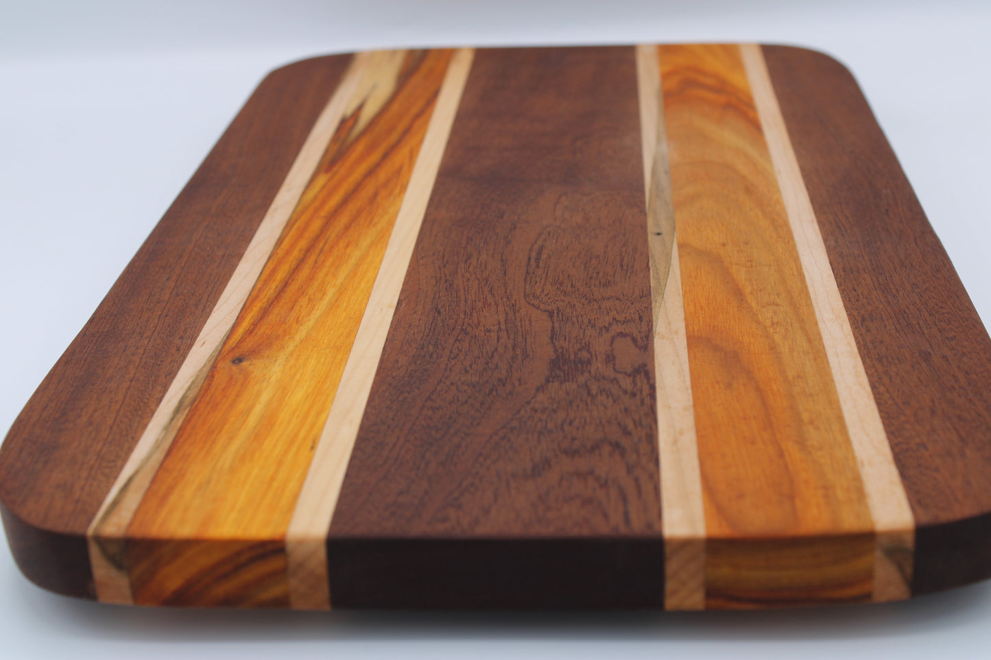 Wooden cutting board with a striped pattern on a white background