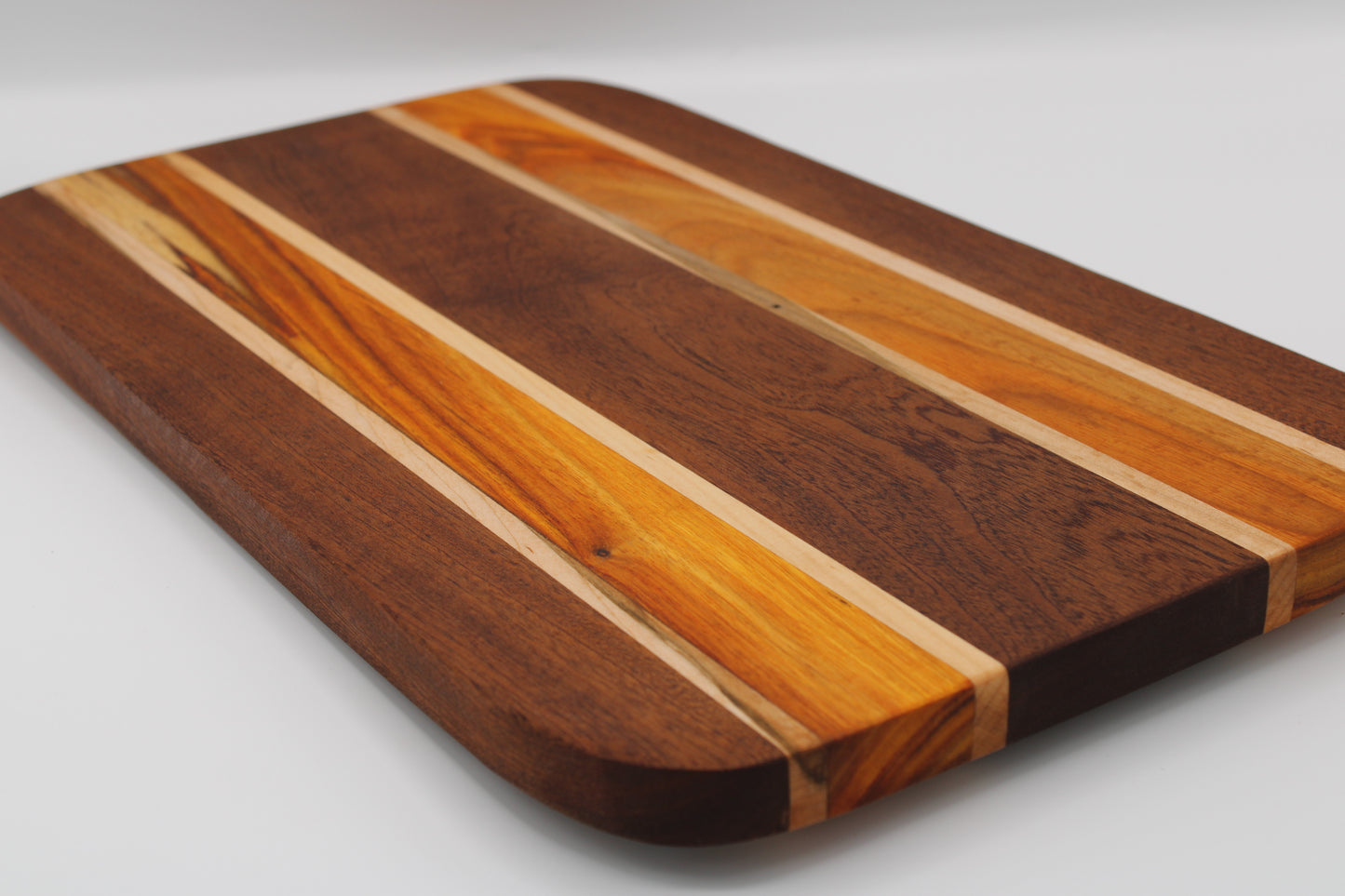 Wooden cutting board with striped pattern on a white background