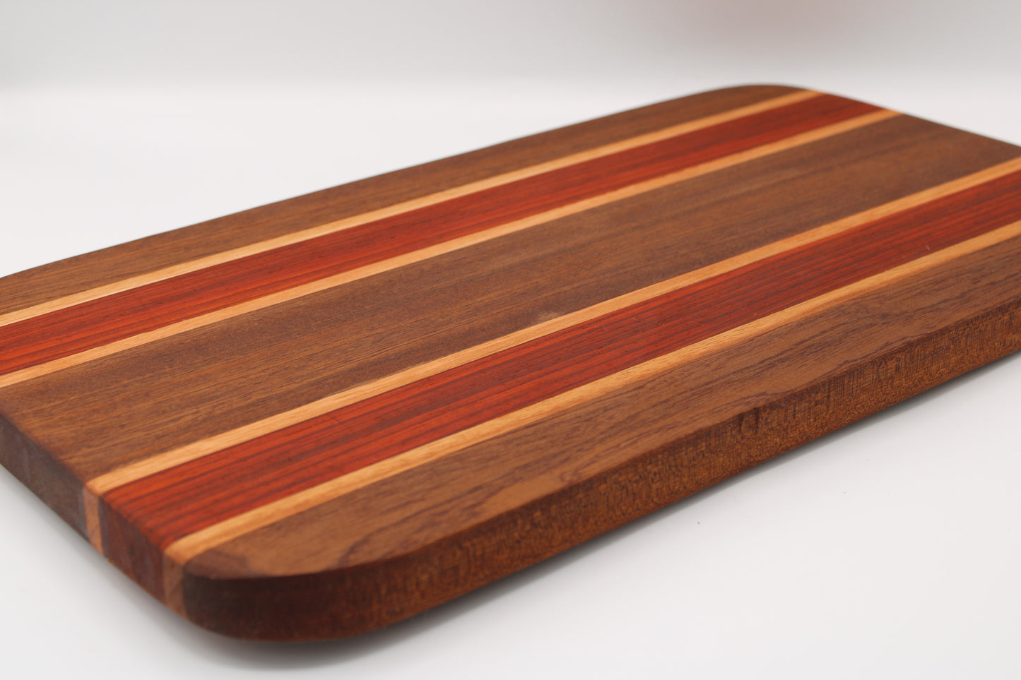 Wooden cutting board with striped pattern on a white background