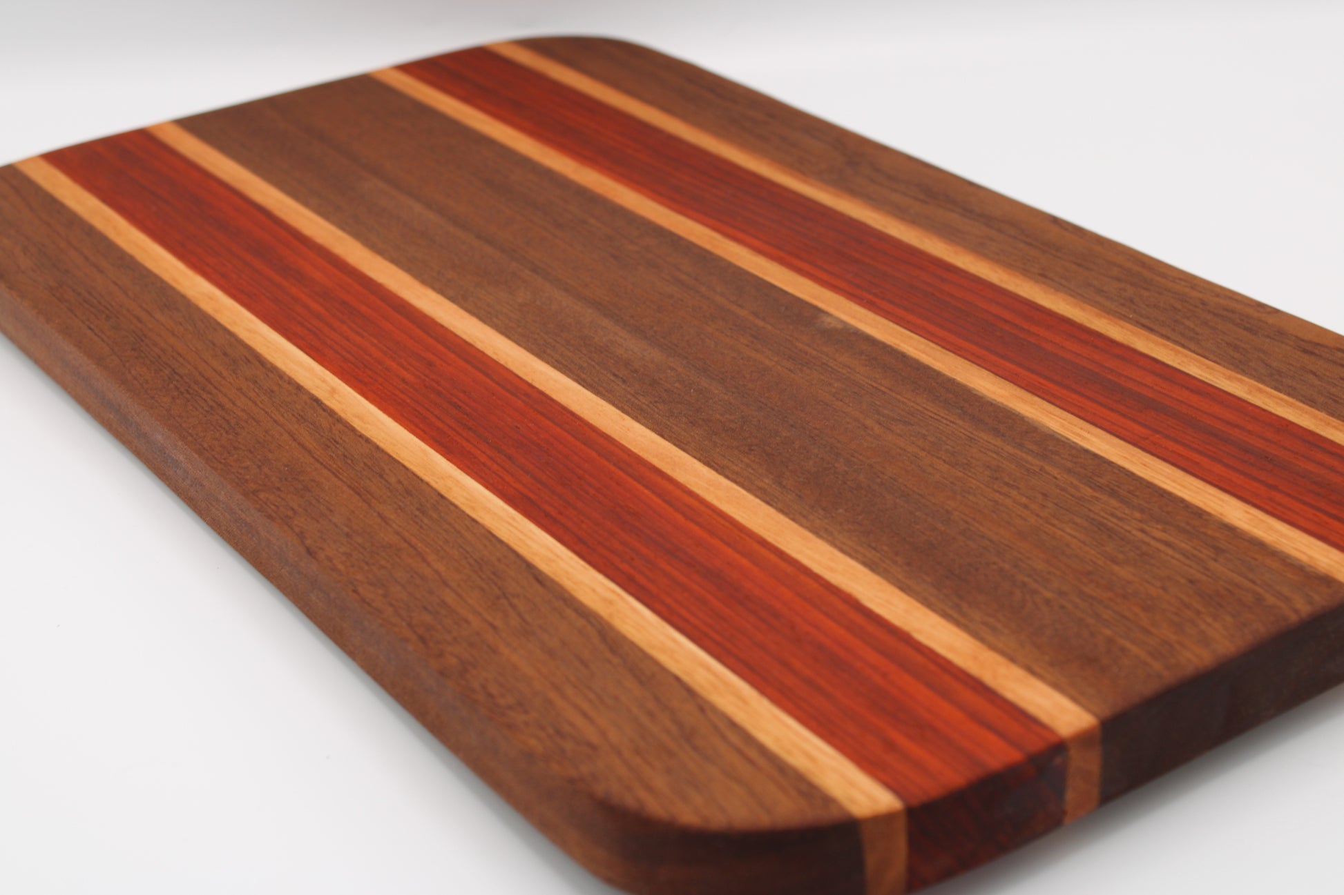 Wooden cutting board with striped pattern on a white background