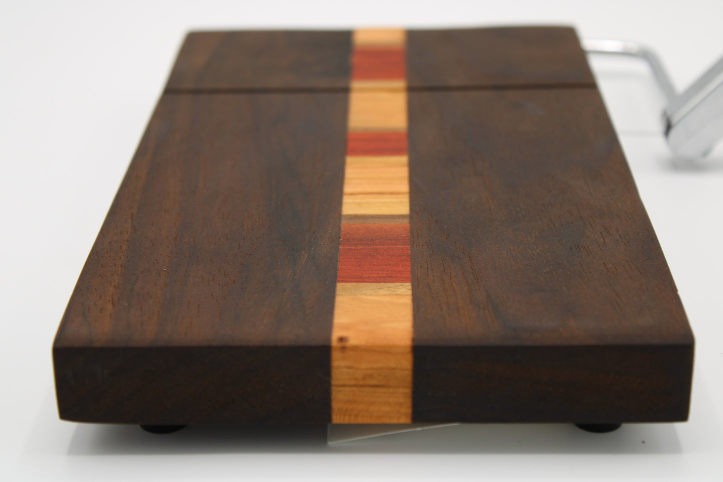 Wooden cutting board with a multicolored stripe on a white background