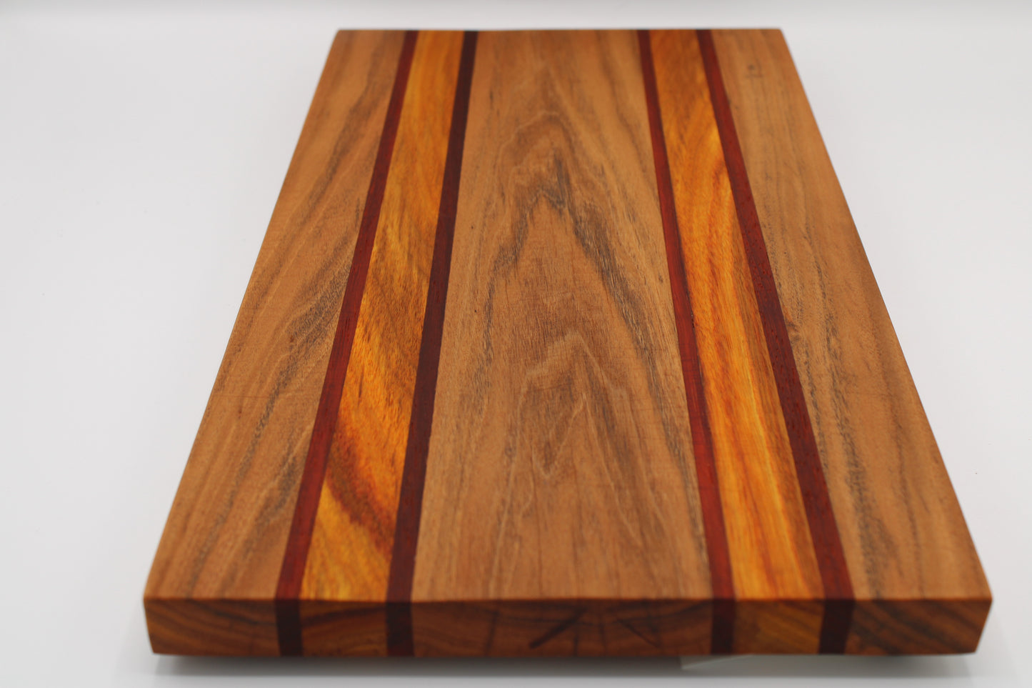 Wooden cutting board with a striped pattern on a white background