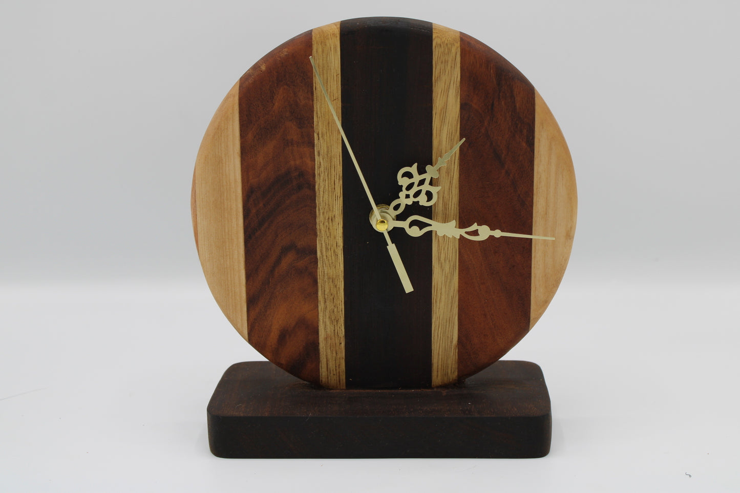 Wooden clock with a unique design on a white background