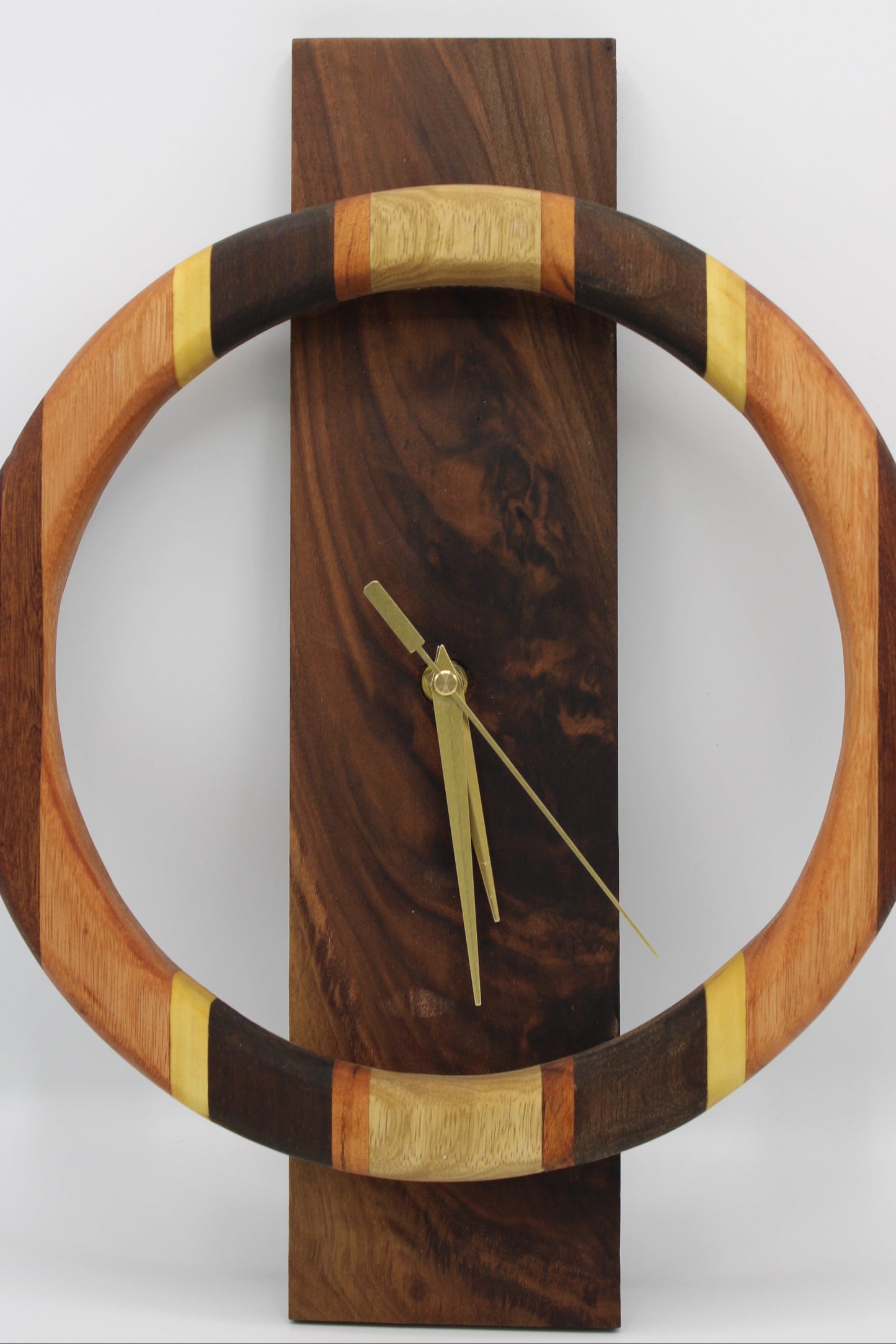 Wooden wall clock with a circular design on a white background