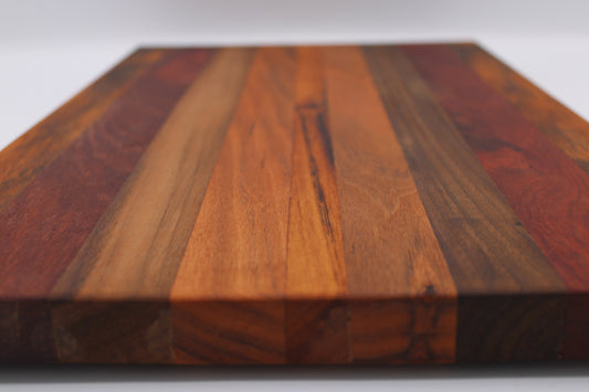 Wooden cutting board with a multicolored grain pattern on a white background