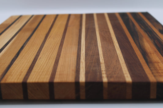 Wooden cutting board with striped pattern on a white background