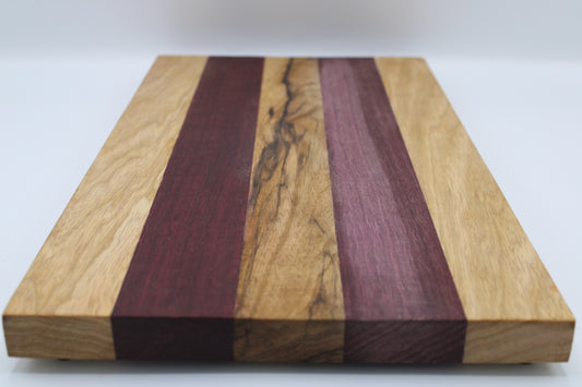 Wooden cutting board with purple and brown stripes on a white background