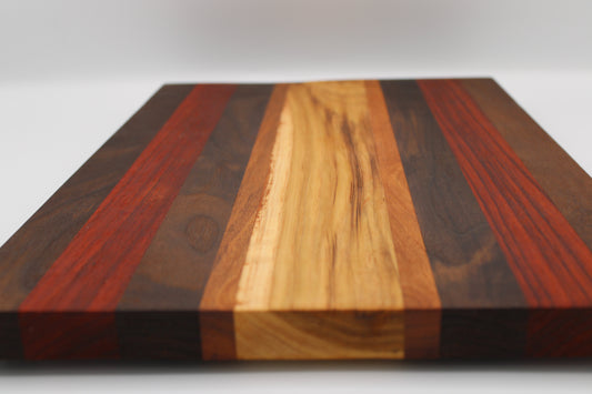 Wooden cutting board with multicolored stripes on a white background