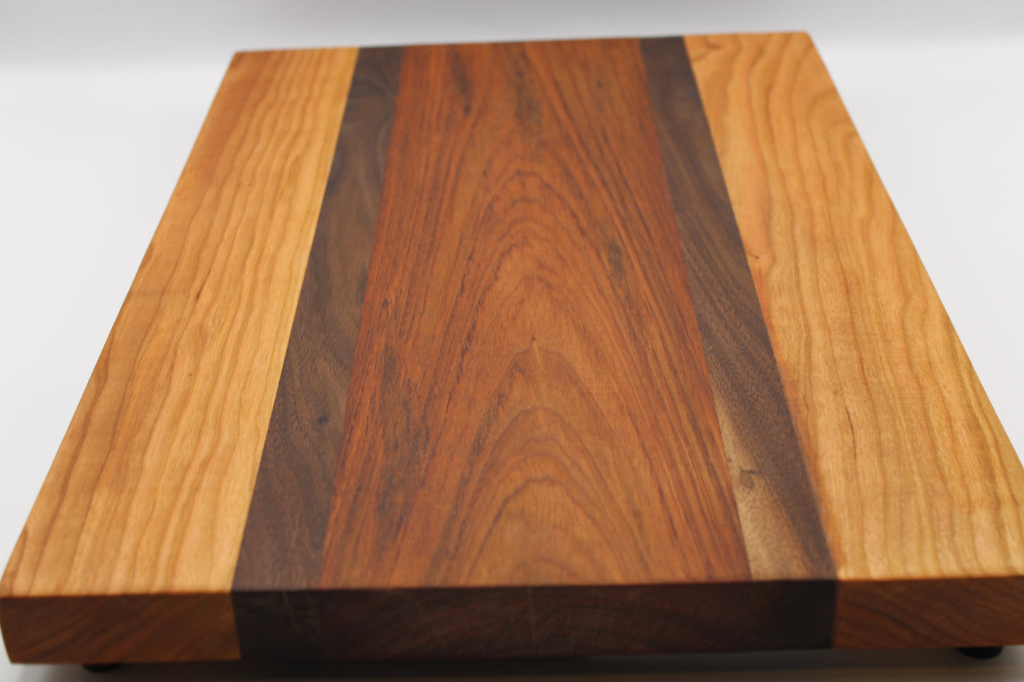 Wooden cutting board with a striped pattern on a white background