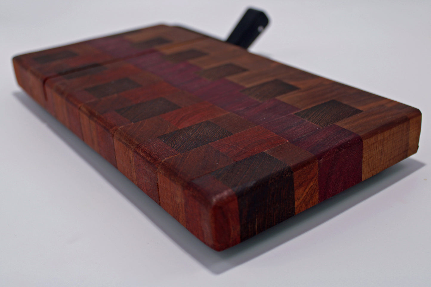 Wooden cheese cutting board with a slicer on a white background