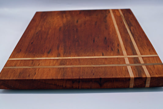 Wooden cutting board with a striped pattern on a white background