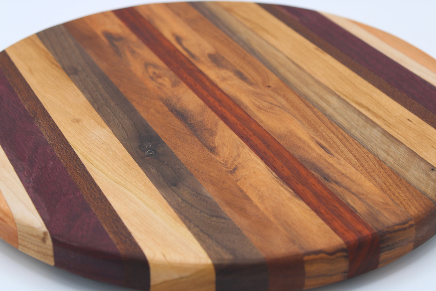 Round wood cutting board will multi color stripes
