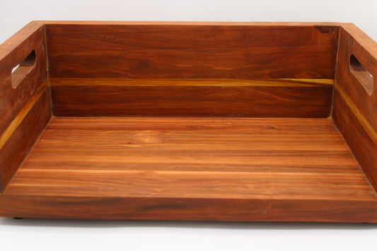 A rectangular wooden serving tray with a warm reddish-brown finish and cutout handles on the sides, shown against a plain white background.