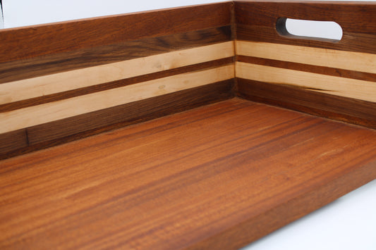 BBQ chopping box with 5 stripes in dark, medium and light brown wood. Handles on sides.