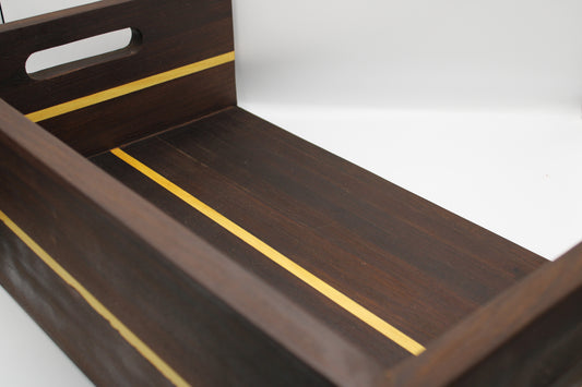 Wooden tray with gold accents on a white background