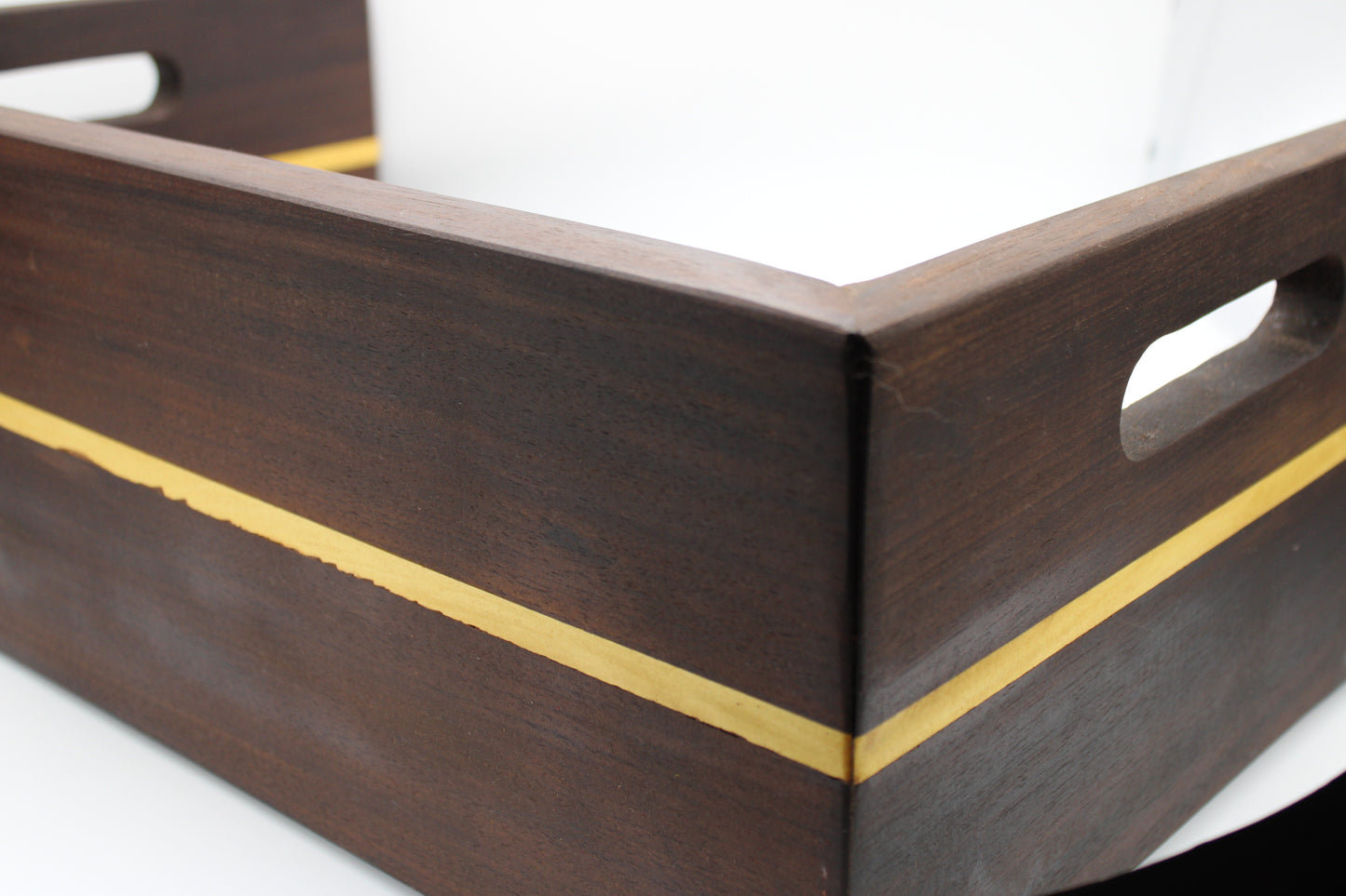 Wooden tray with gold inlay on a white background