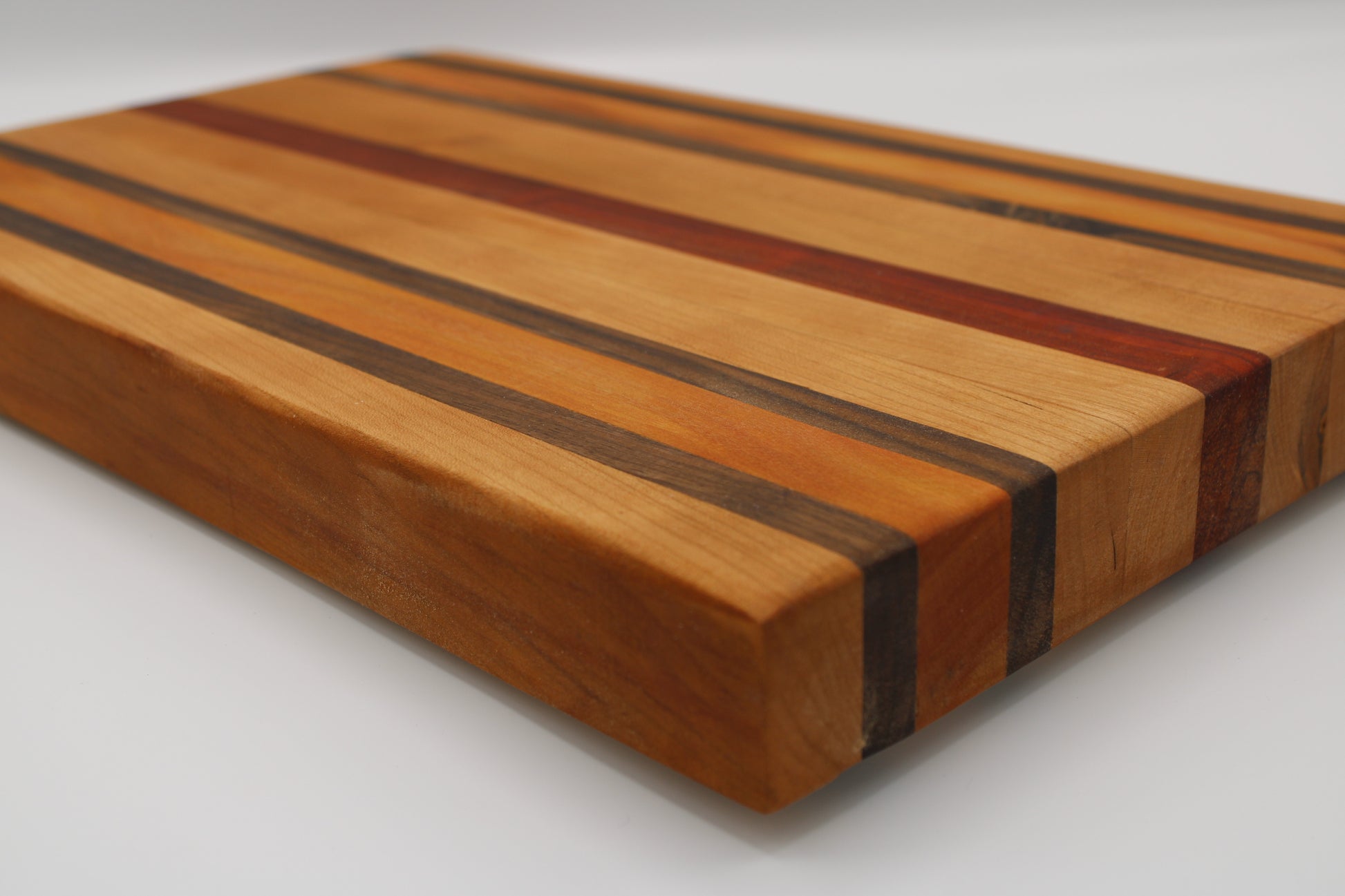 Wooden cutting board with striped pattern on a white background