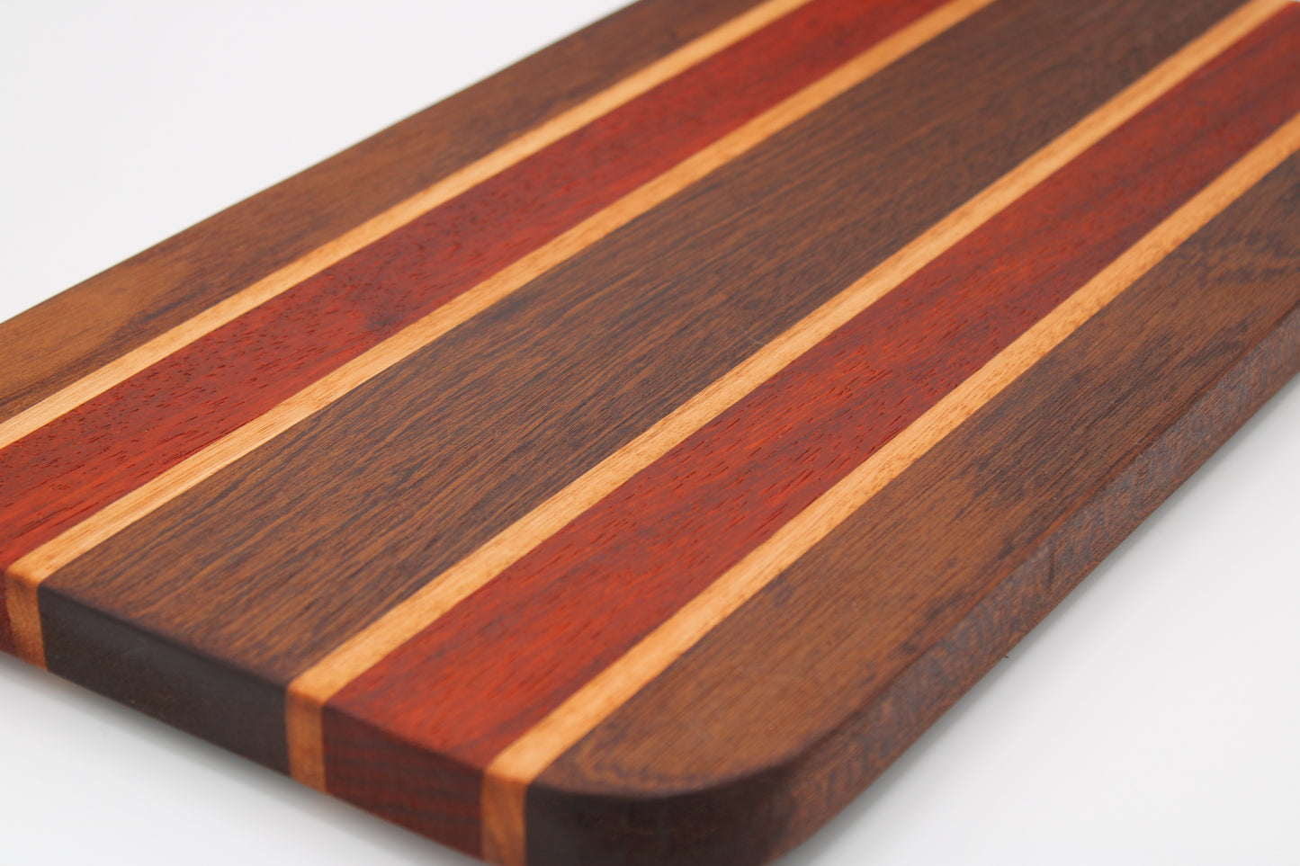 Wooden cutting board with striped pattern on a white background