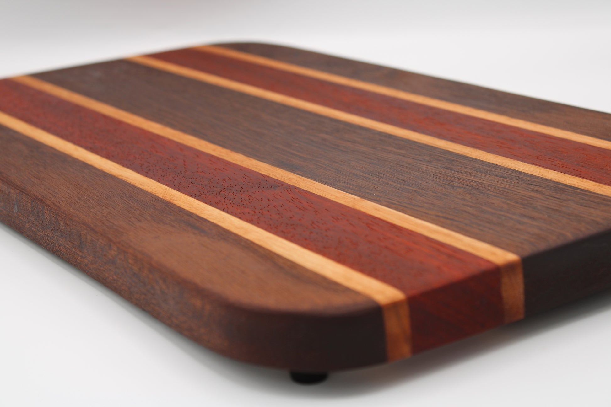 Wooden cutting board with striped pattern on a white background