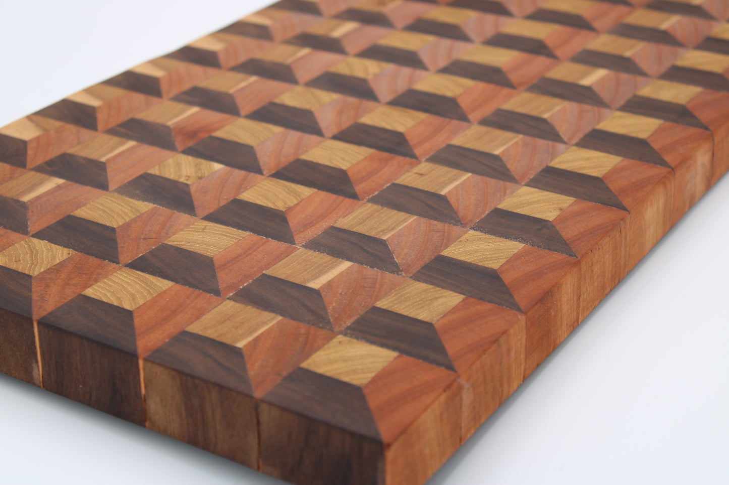 Wooden cutting board with geometric pattern on a white background