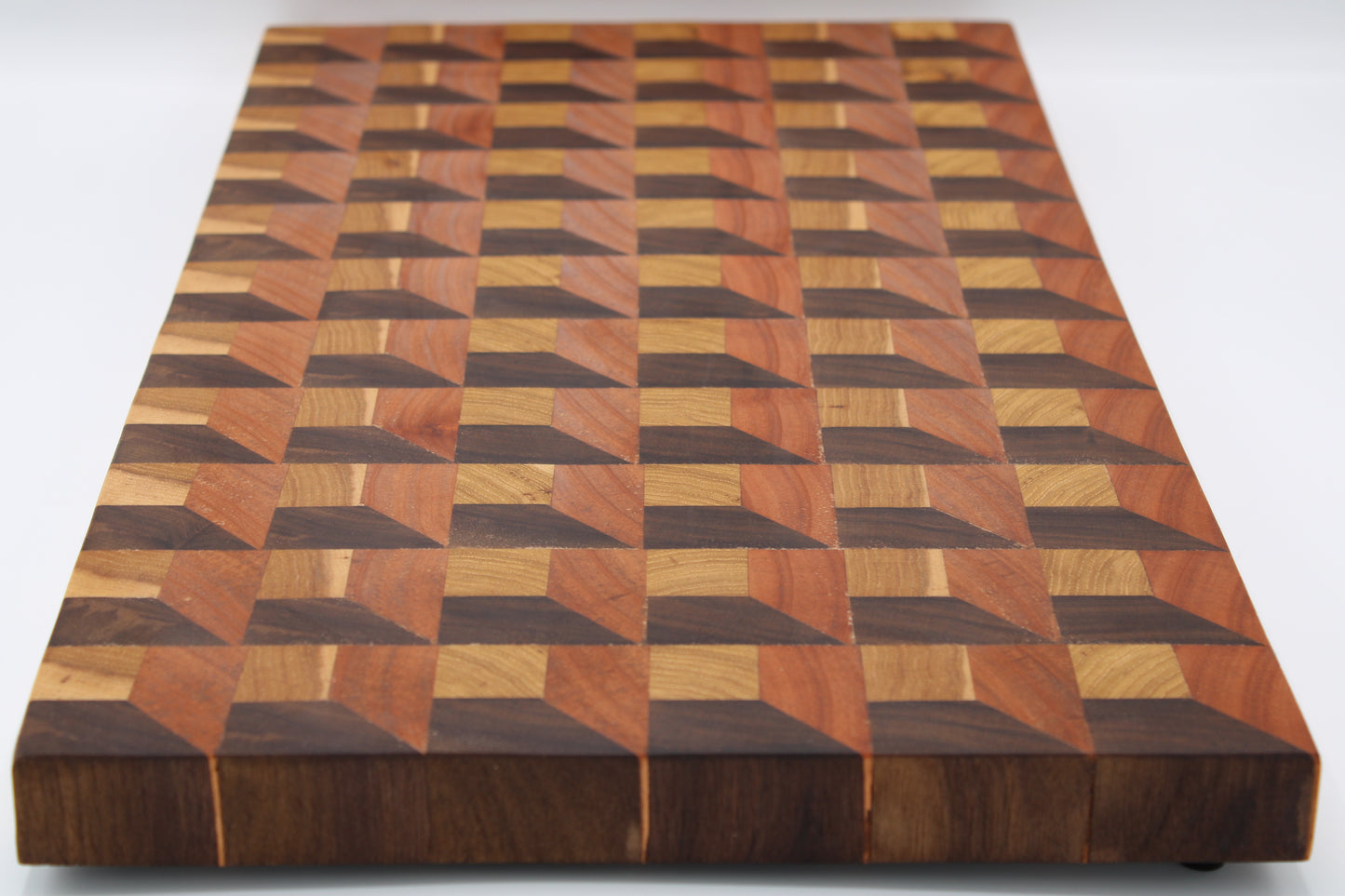 Wooden cutting board with a geometric pattern on a white background