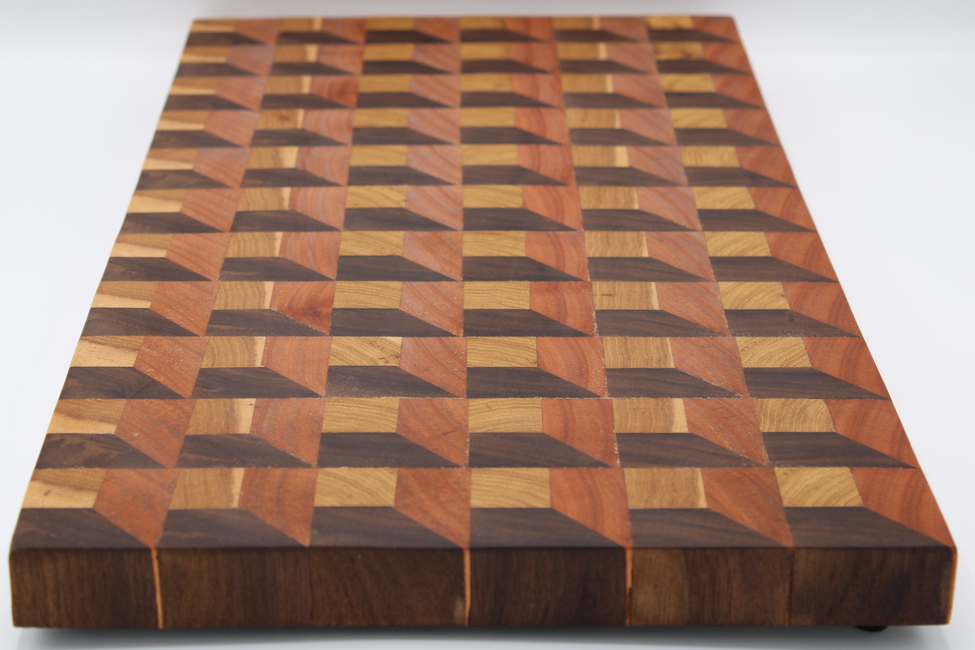 Wooden cutting board with a geometric pattern on a white background