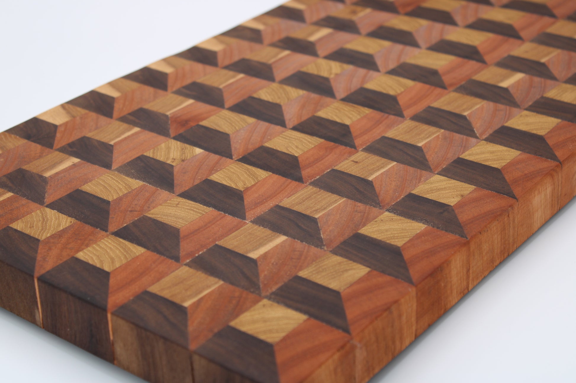 Wooden cutting board with geometric pattern on a white background