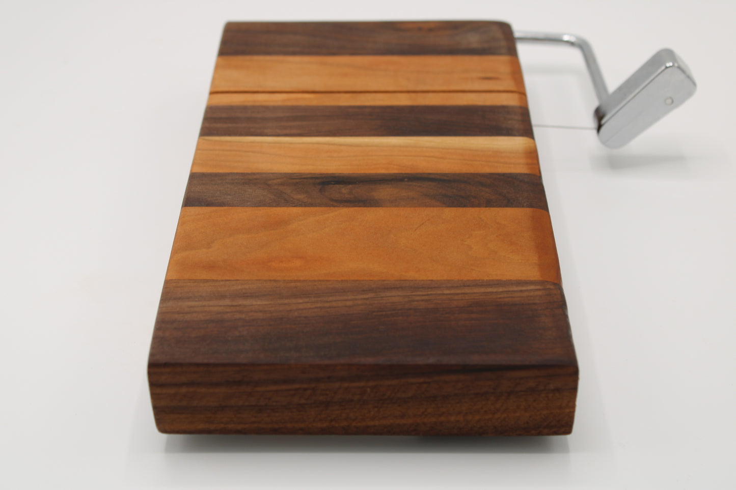 Wooden cheese  board with slicer on a white background