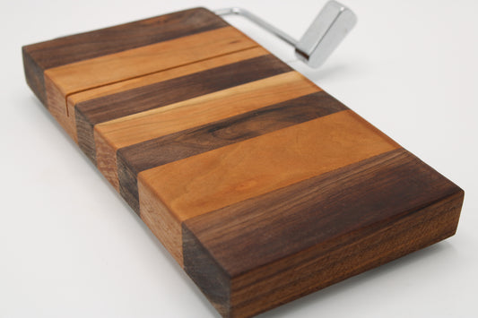 Wooden cheese  board with slicer on a white background