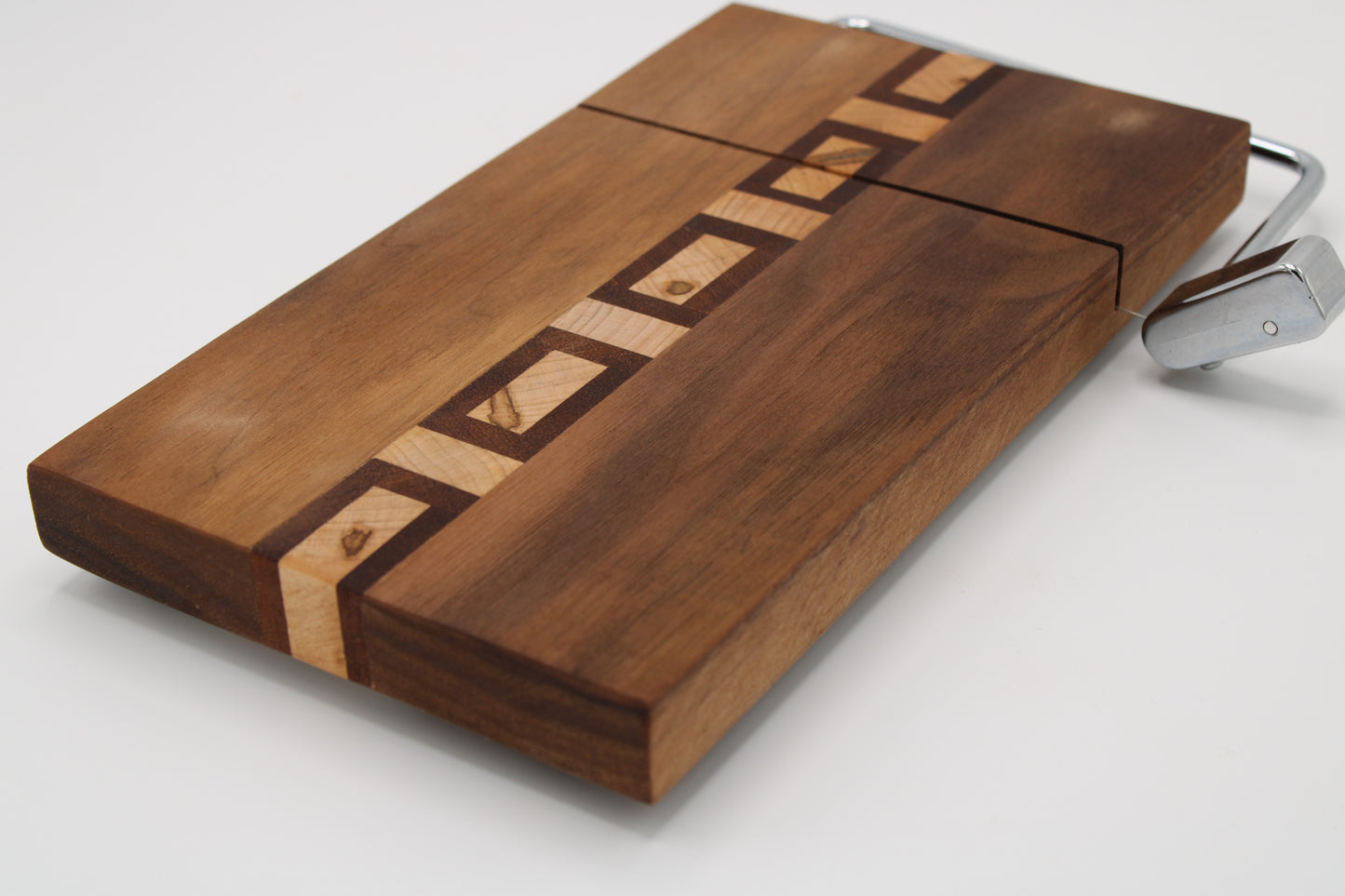 Wooden cutting board with geometric pattern on a white background