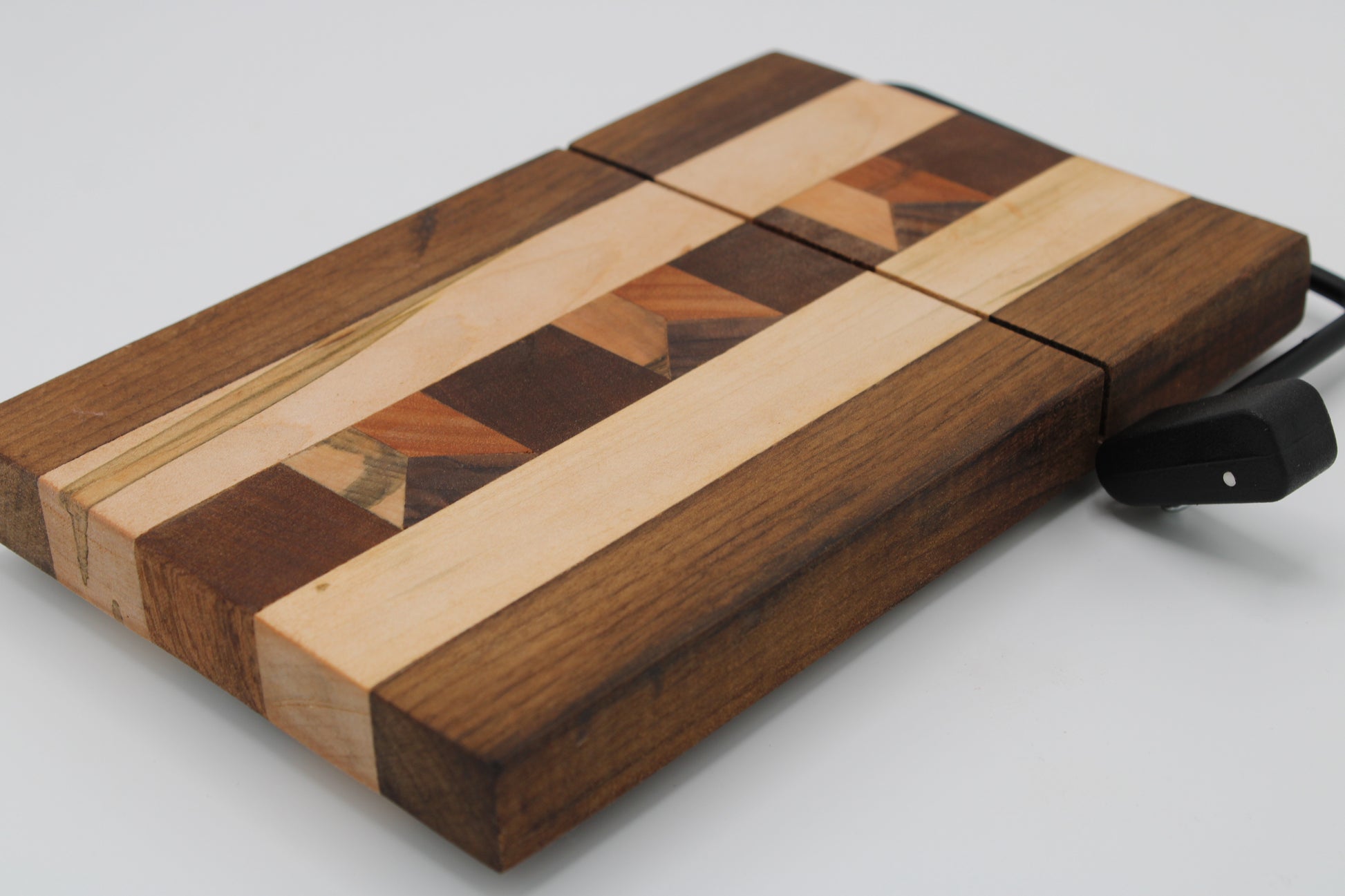 Wooden cheese  board with slicer on a white background