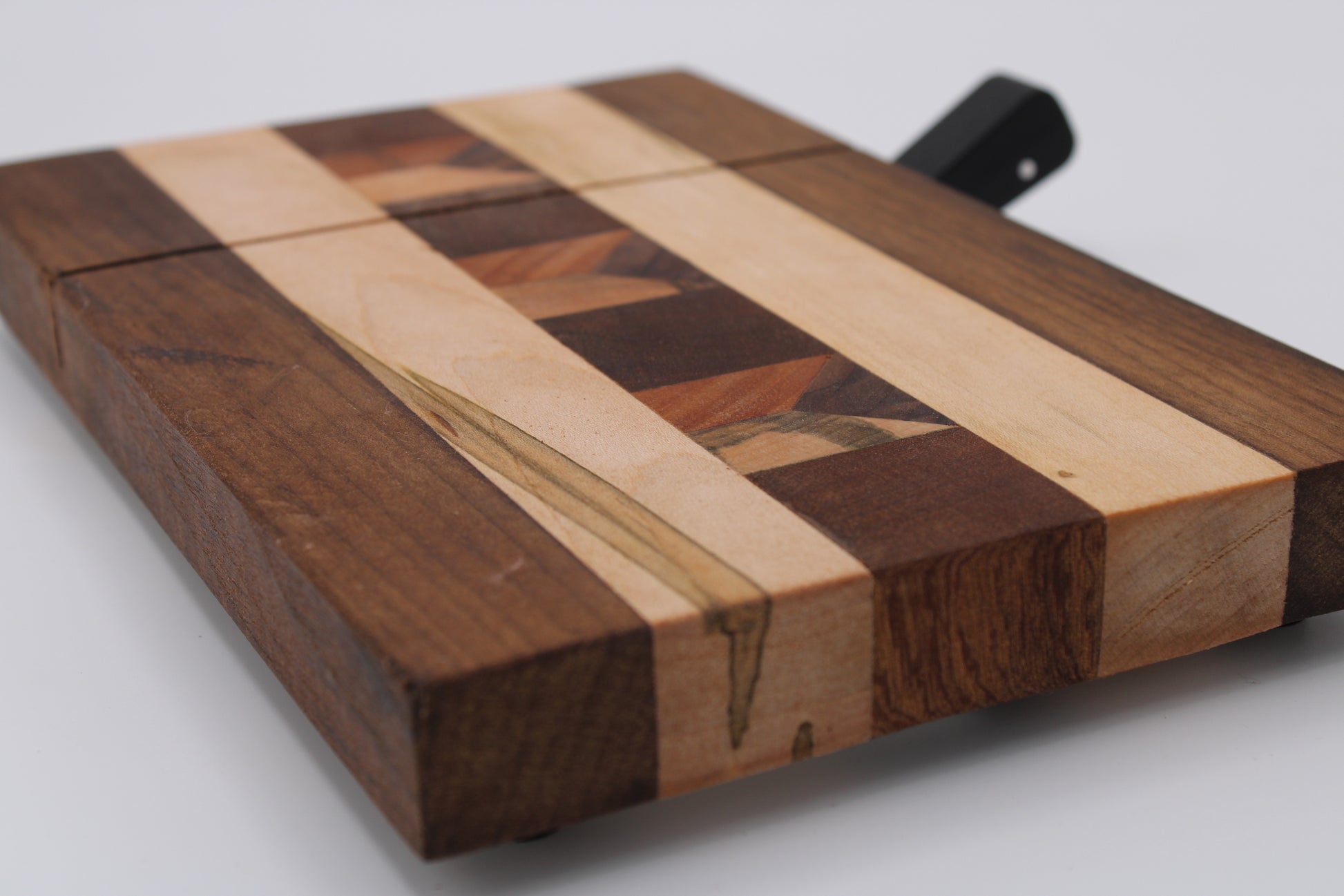 Wooden cheese  board with slicer on a white background