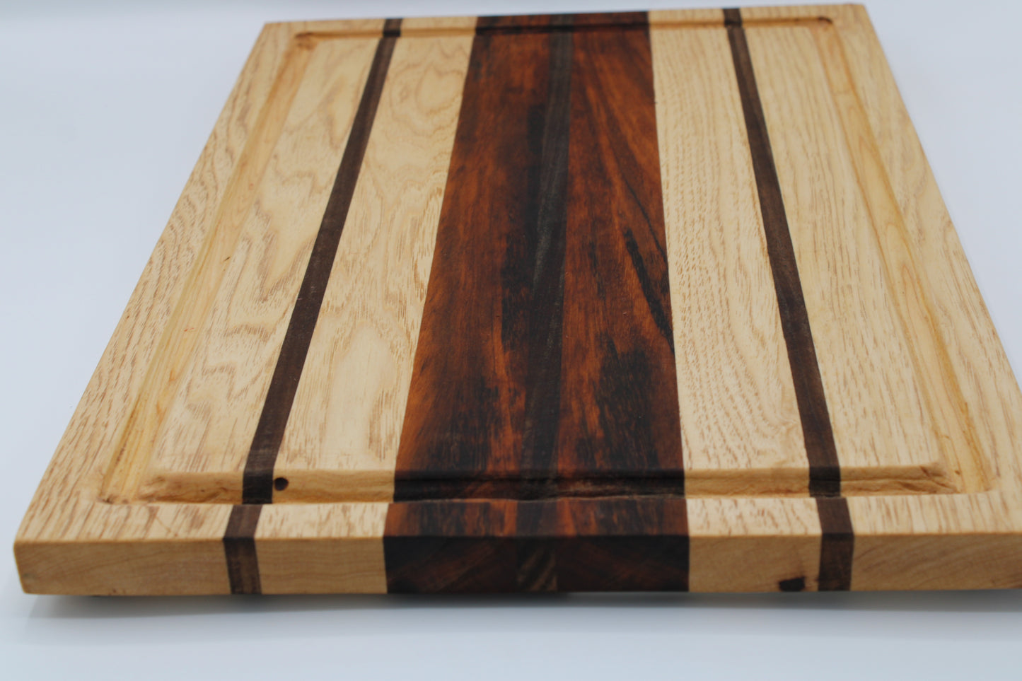 Wooden cutting board with a striped pattern on a white background