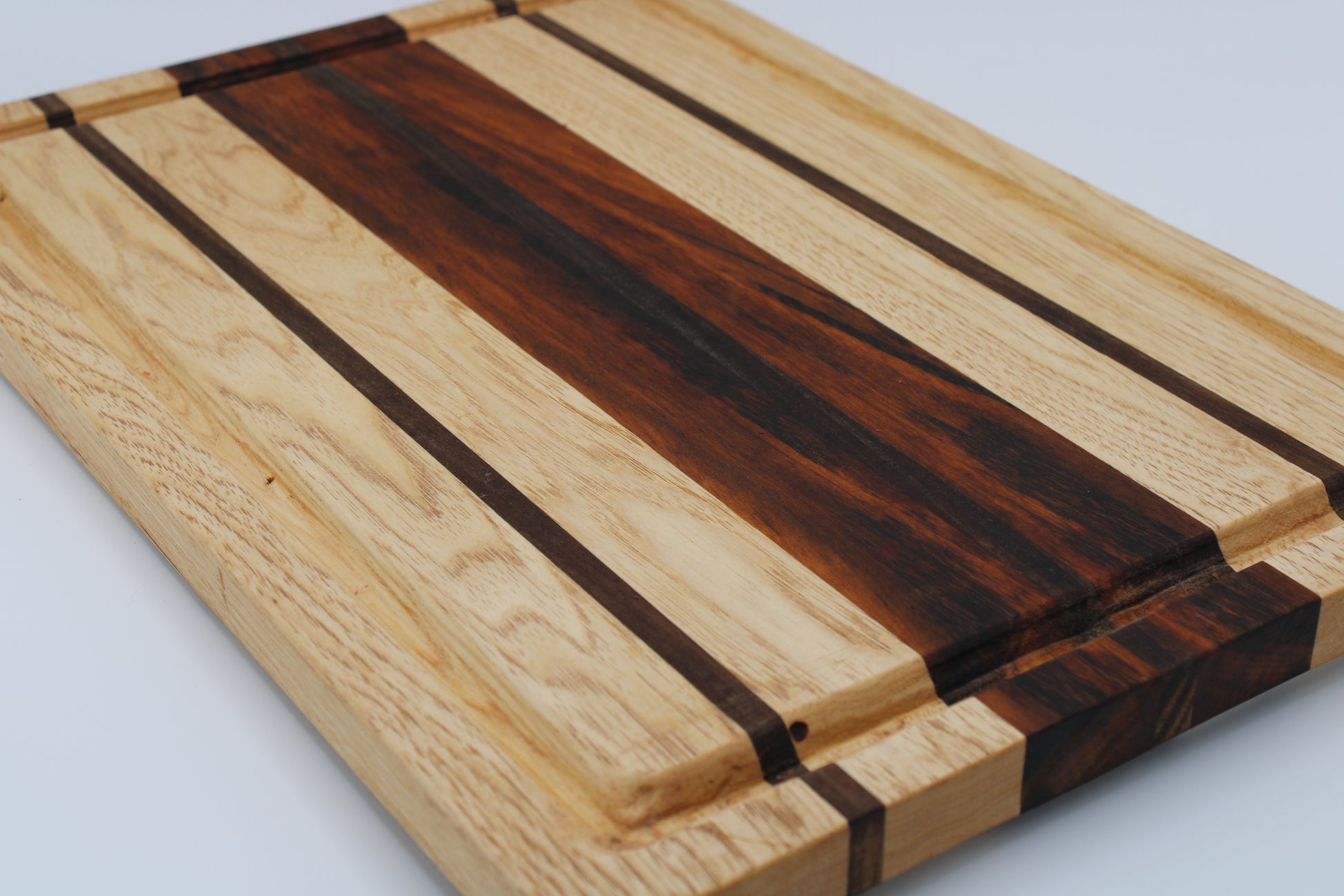 Wooden cutting board with a striped pattern on a white background