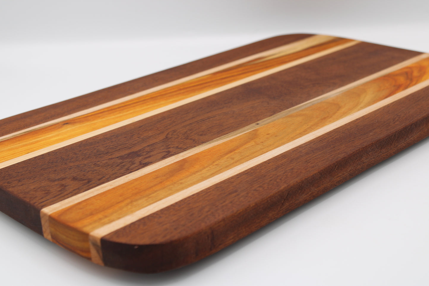 Wooden cutting board with striped pattern on a white background