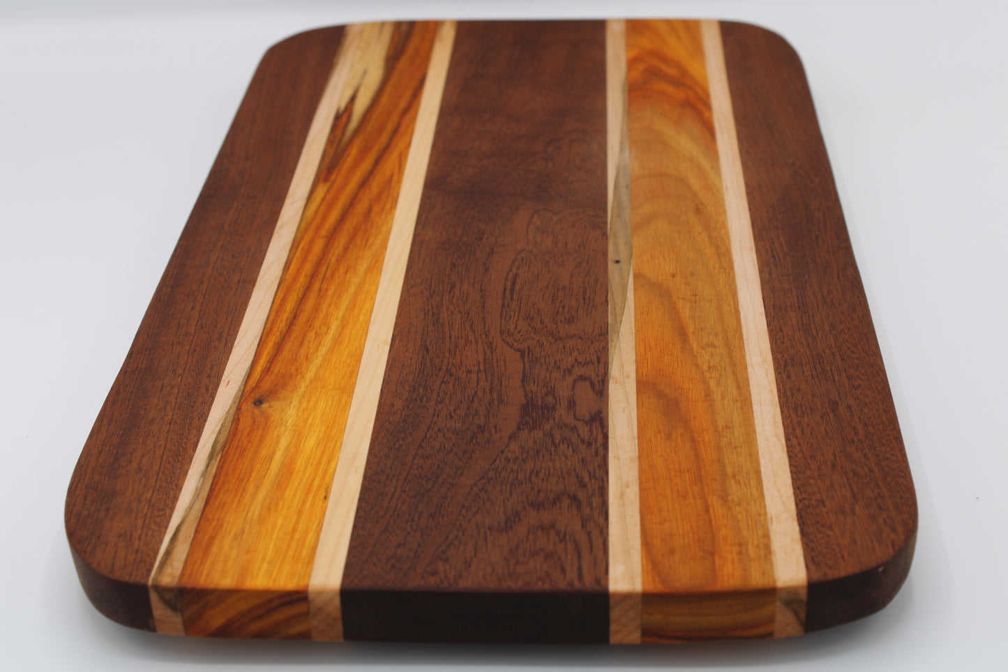Wooden cutting board with a striped pattern on a white background